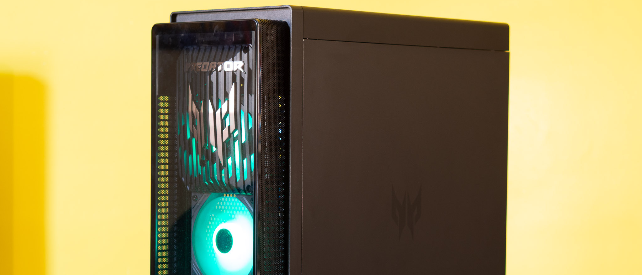 Acer Predator Orion 7000 gaming desktop PC on a wooden desk and yellow background