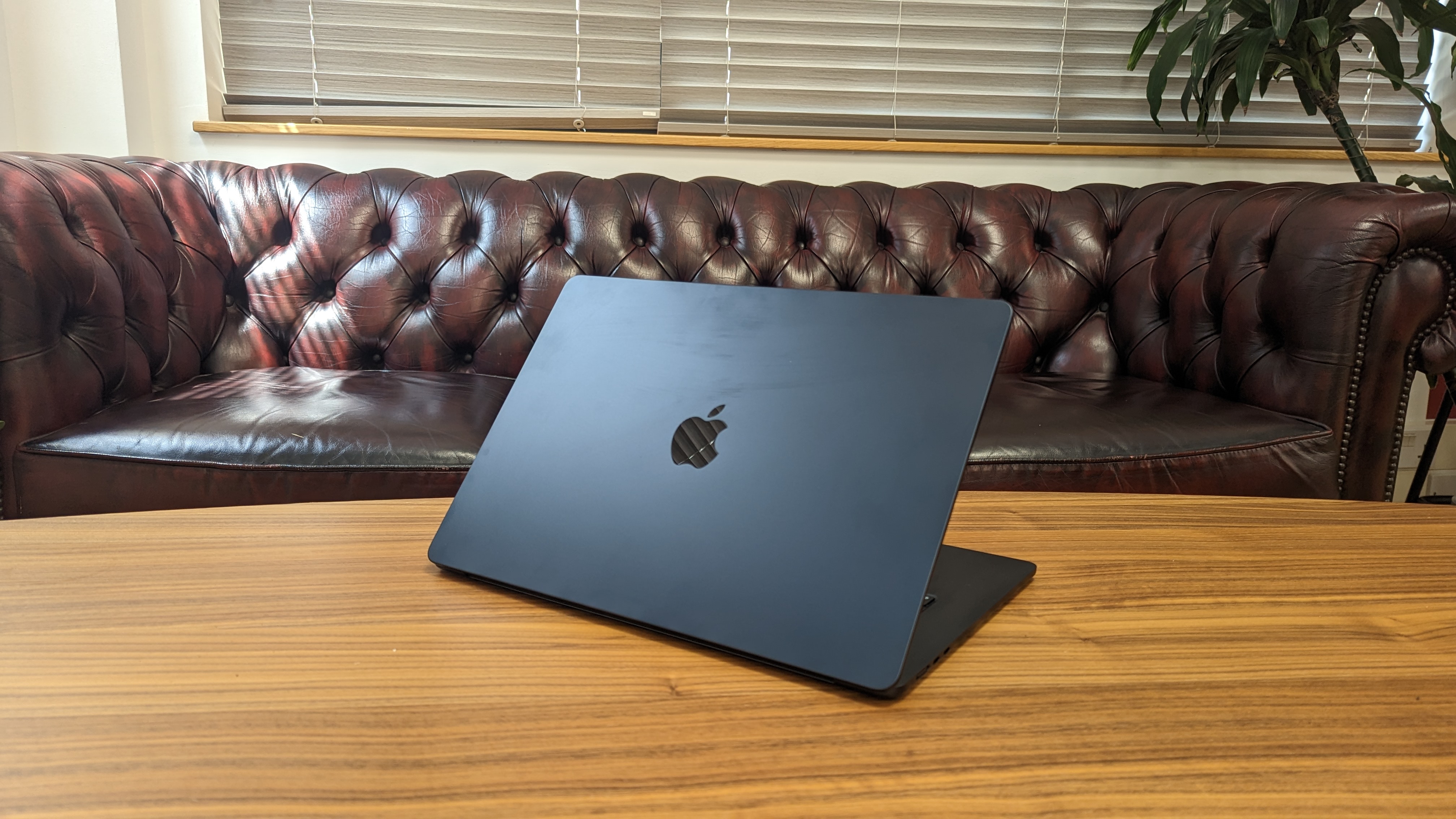 15-inch MacBook Air on wooden table at home
