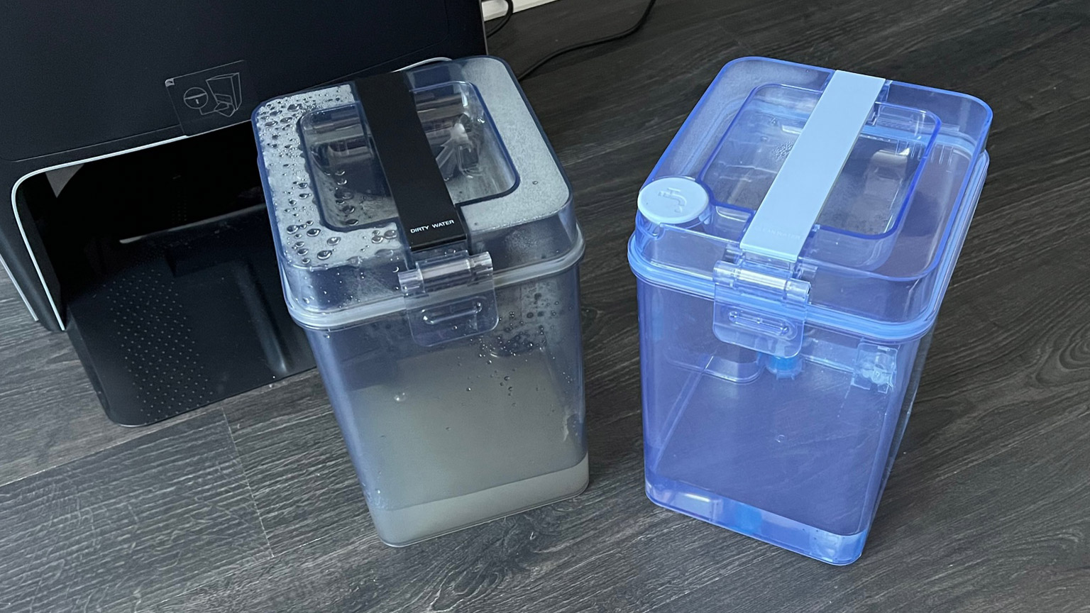 The dirty and clean water tanks removed from the docking station that ships with the Ecovacs Deebot X1 Omni