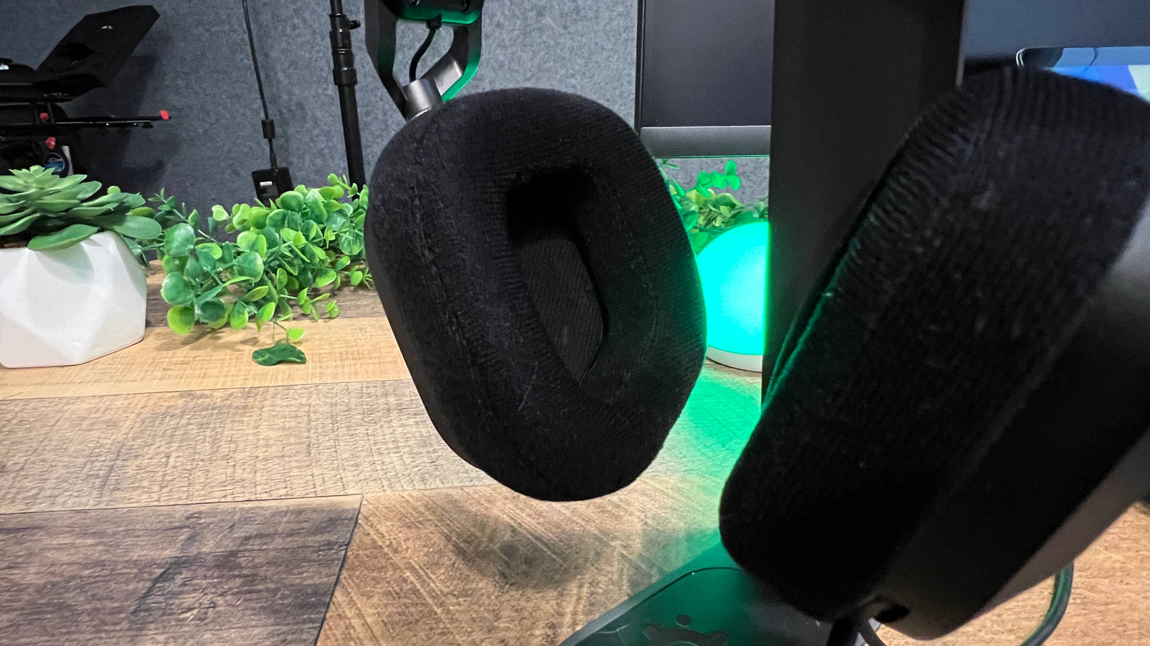 A Corsair HS80 USB on a headset holder on a desk