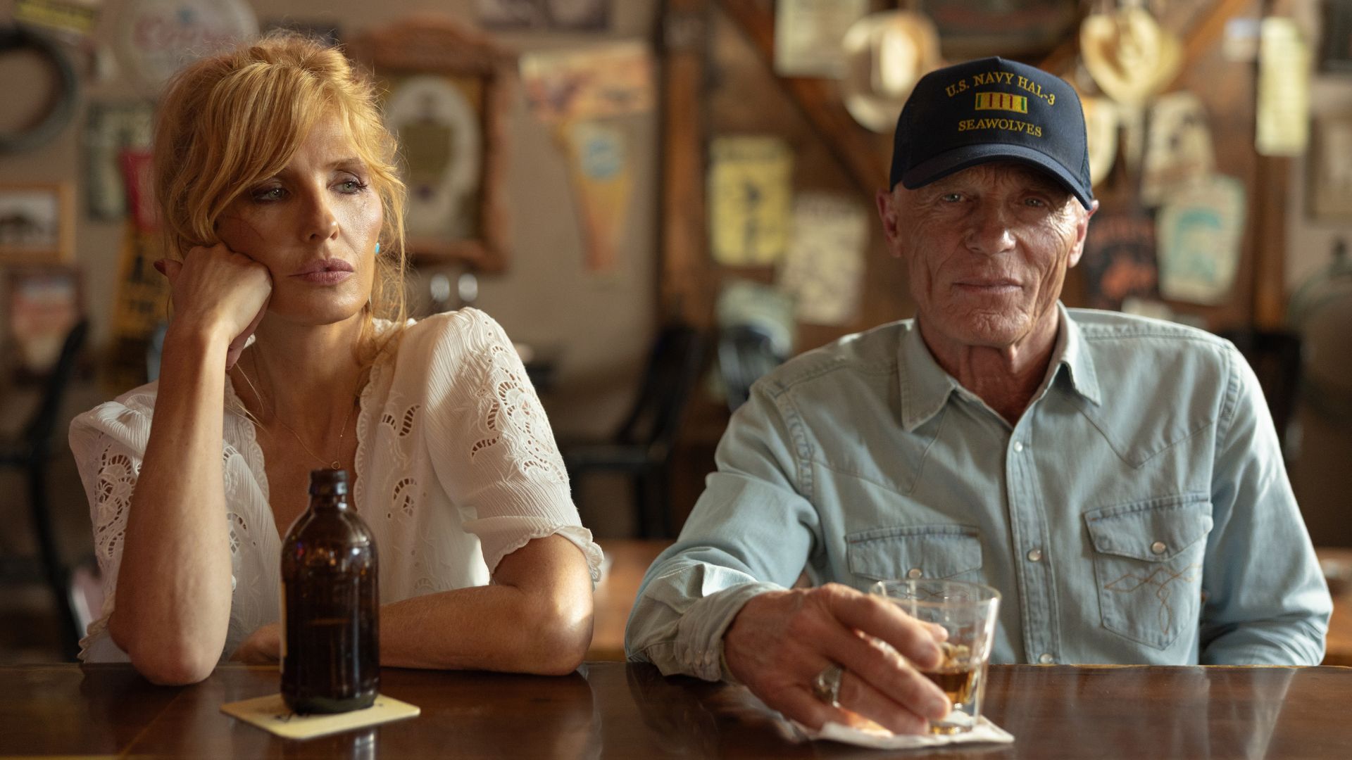 Beth and Everett drink at a bar
