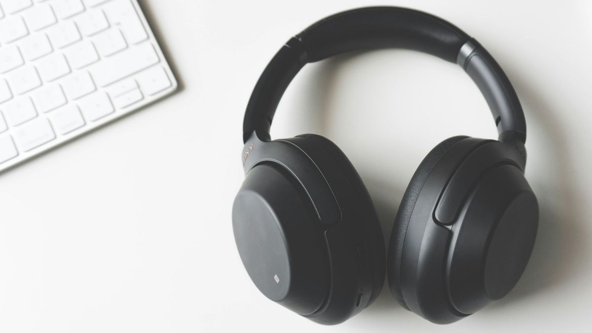 Image of a pair of headphones next to a keyboard