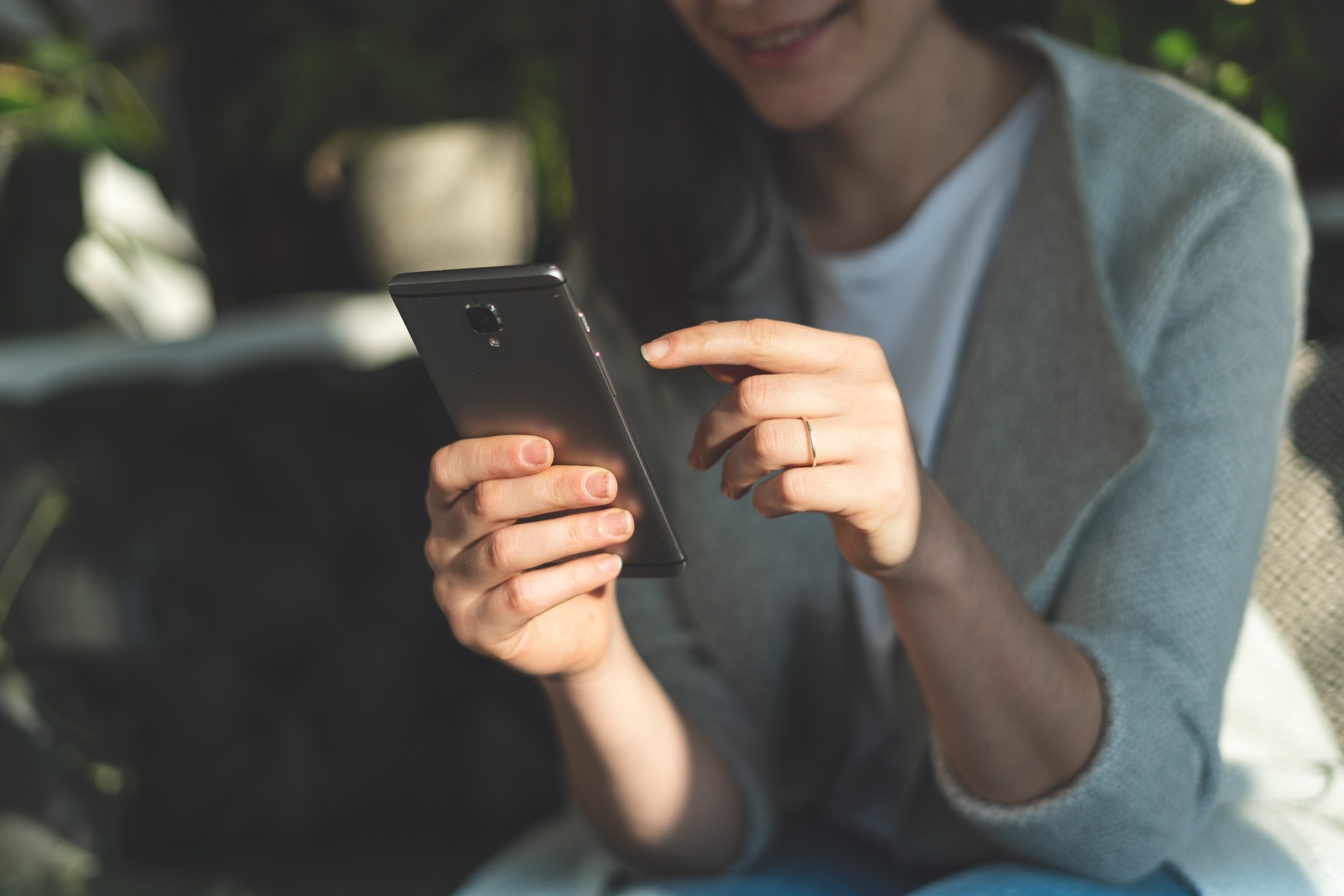 A woman using an Android phone.