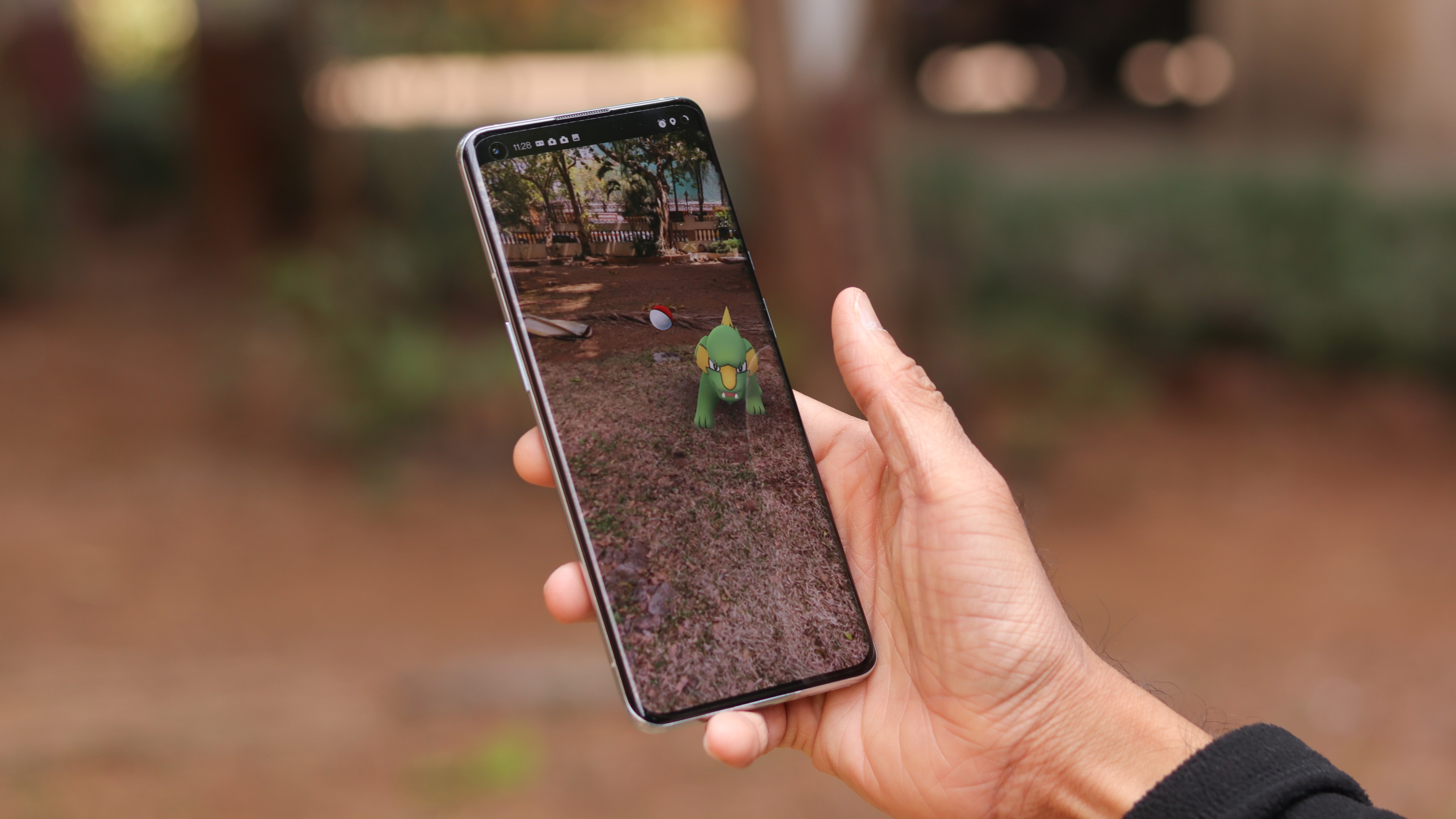 A OnePlus 9 Pro from the front, in someone's hand