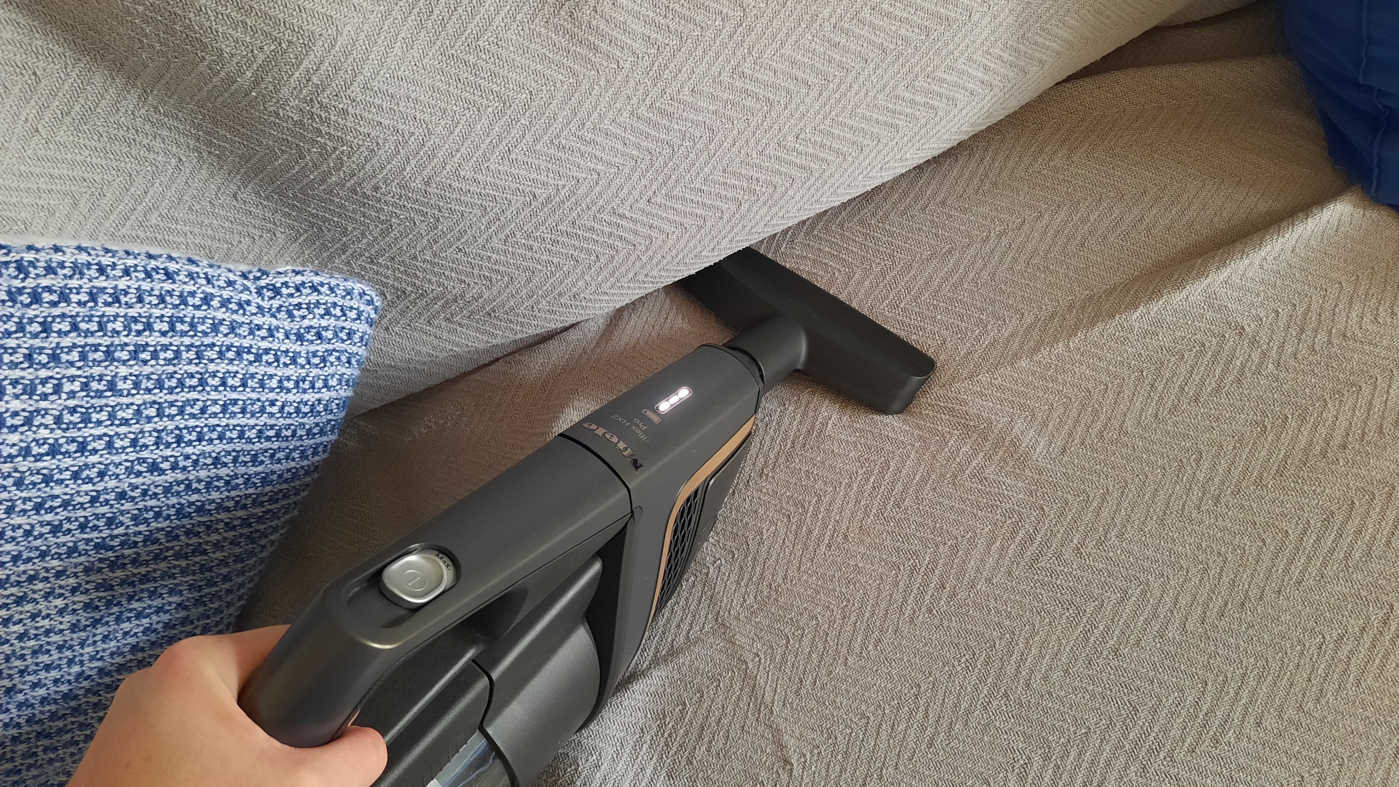 Miele Triflex Hx2 being used as a handheld on couch