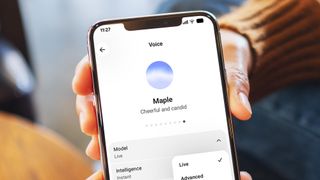 A hand holding a phone showing ChatGPT's voice mode