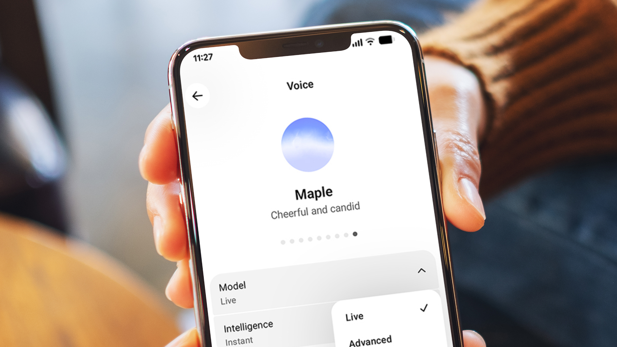 A hand holding a phone showing ChatGPT's voice mode