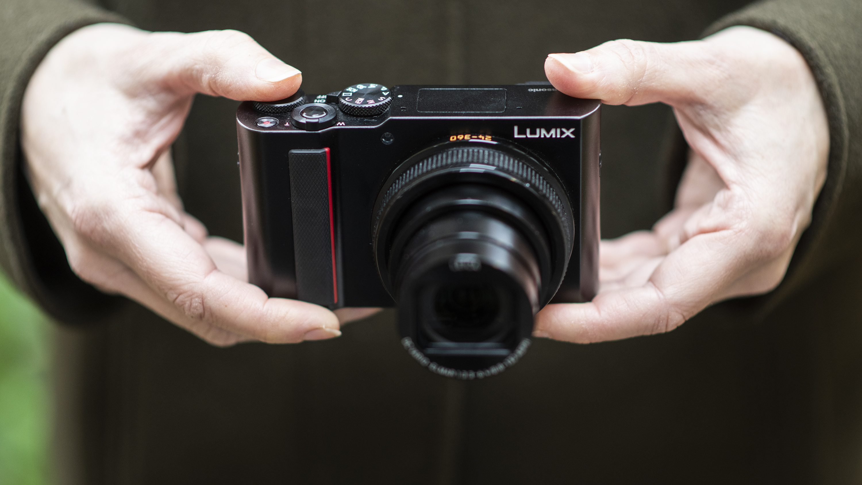 The Panasonic TZ200 being held in two hands