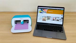 Cricut Joy beside a laptop with the desktop app