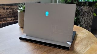 Alienware X14 on a table next to a cactus or something