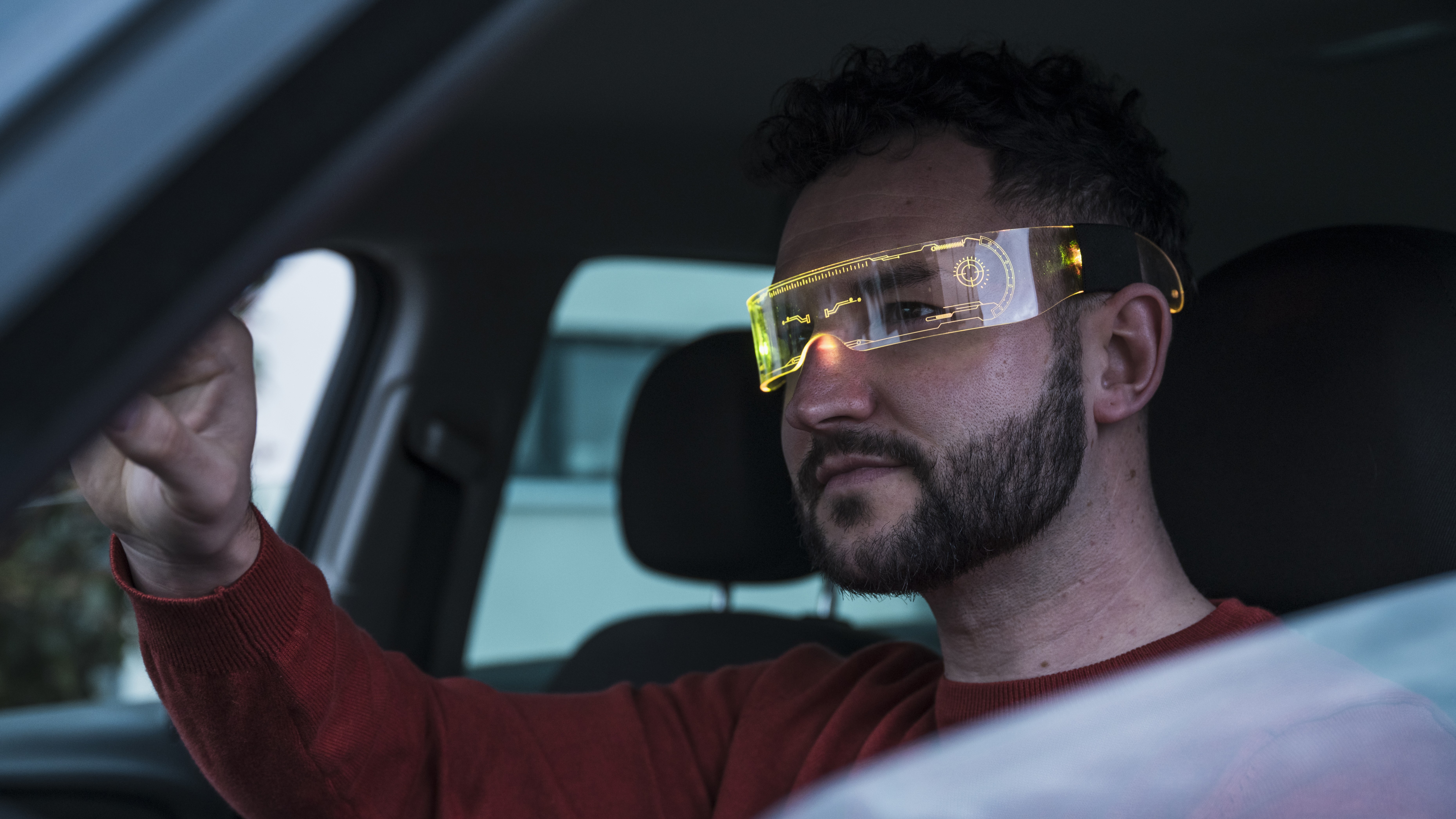 Smiling man wearing smart glasses in car