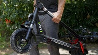 A customer holding their foldable iSinwheel bike
