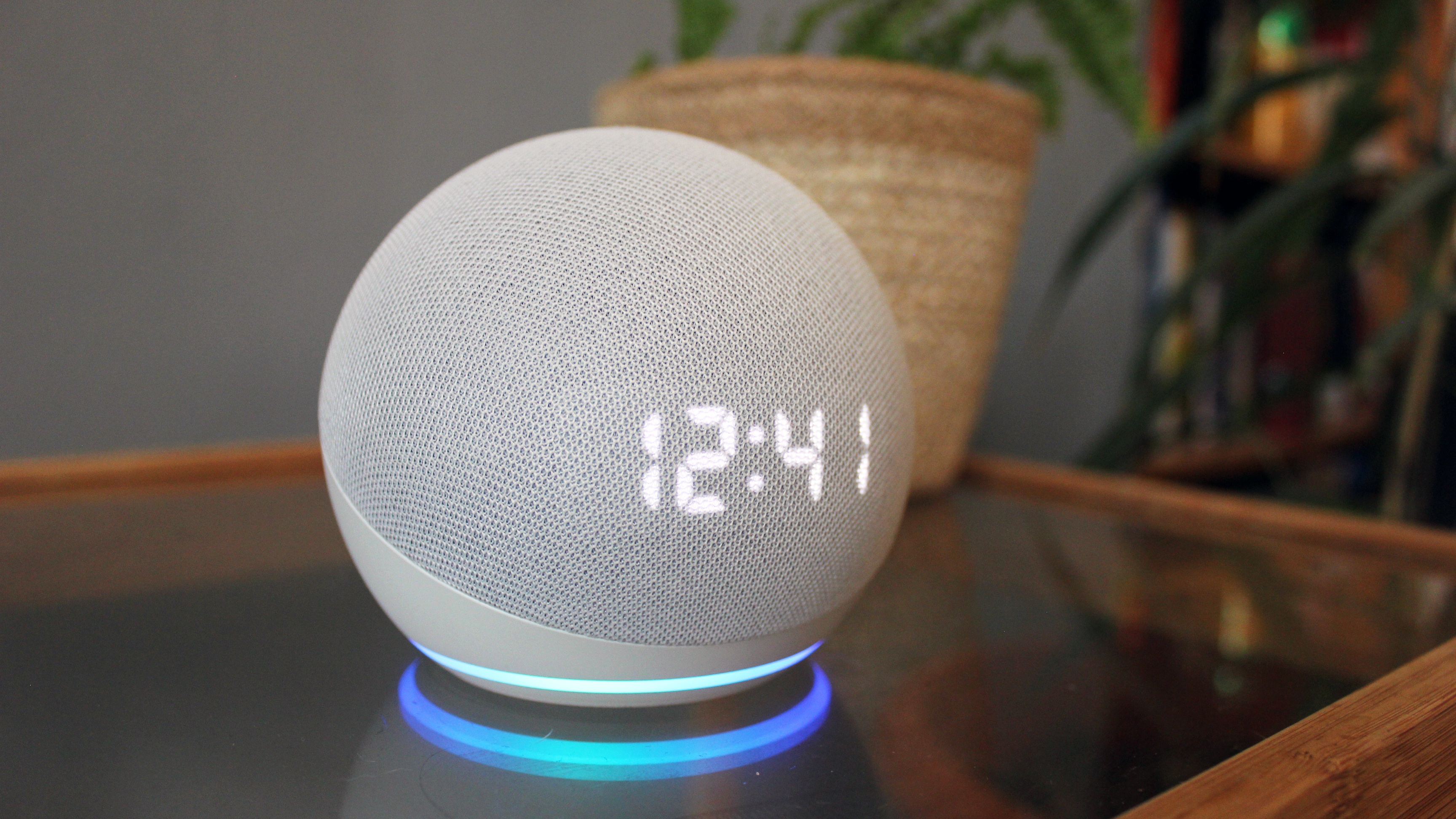 the amazon echo dot with clock on a glass table
