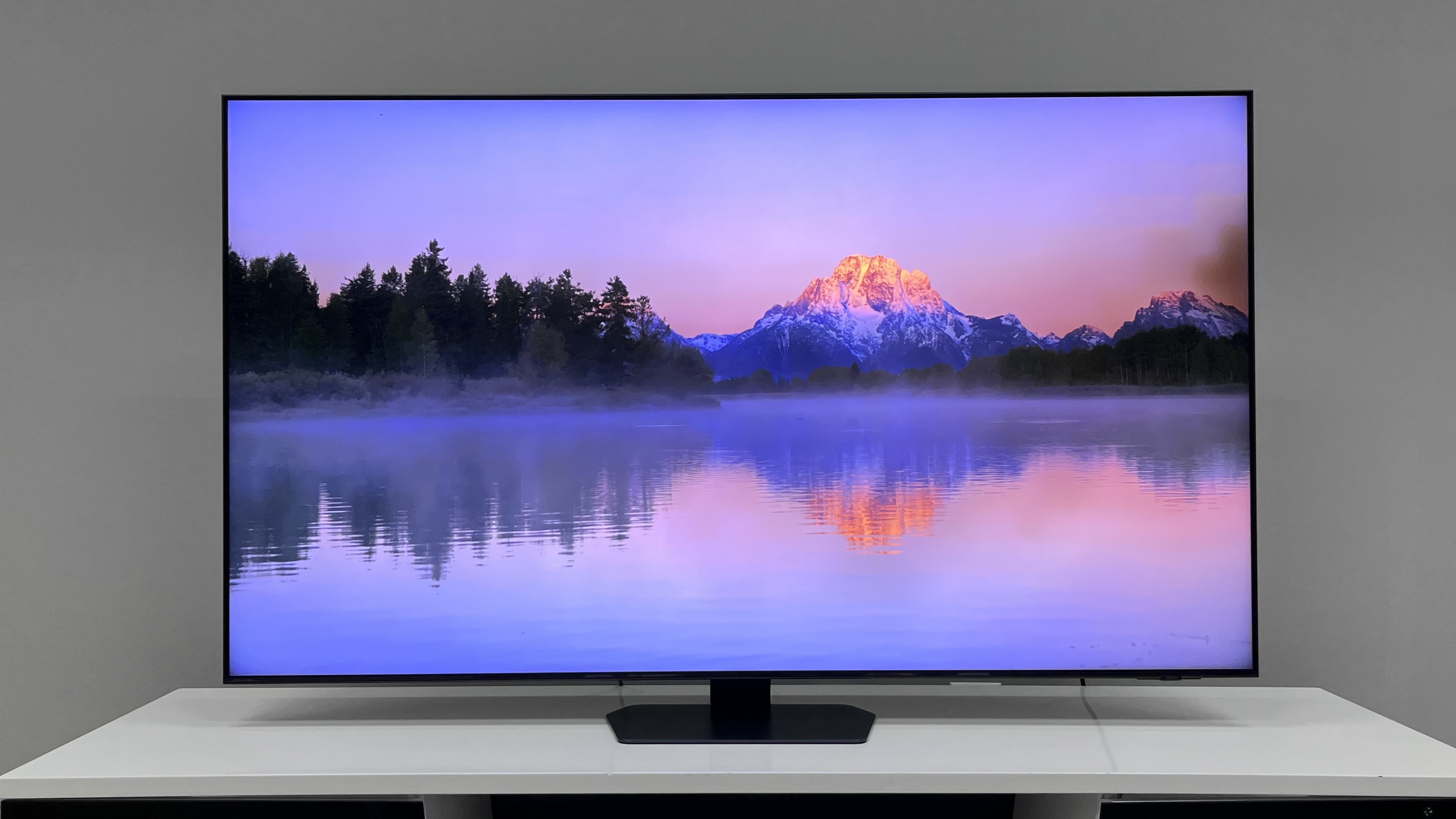 Samsung QN90D on table showing image of mountains