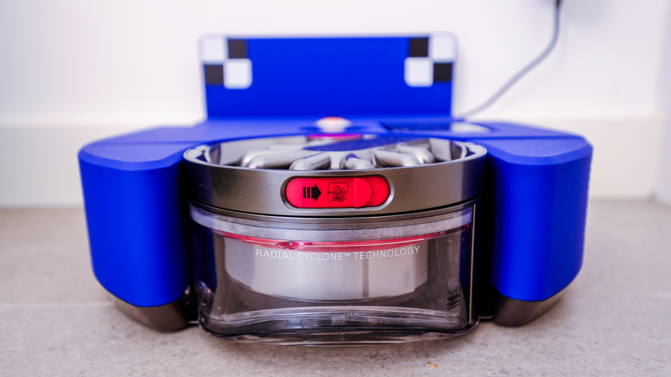 The switch to open the bin of the Dyson 360 Vis Nav