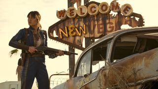 Lucy MacLean holding a shotgun next to a rusty car near New Vegas in Fallout season 2