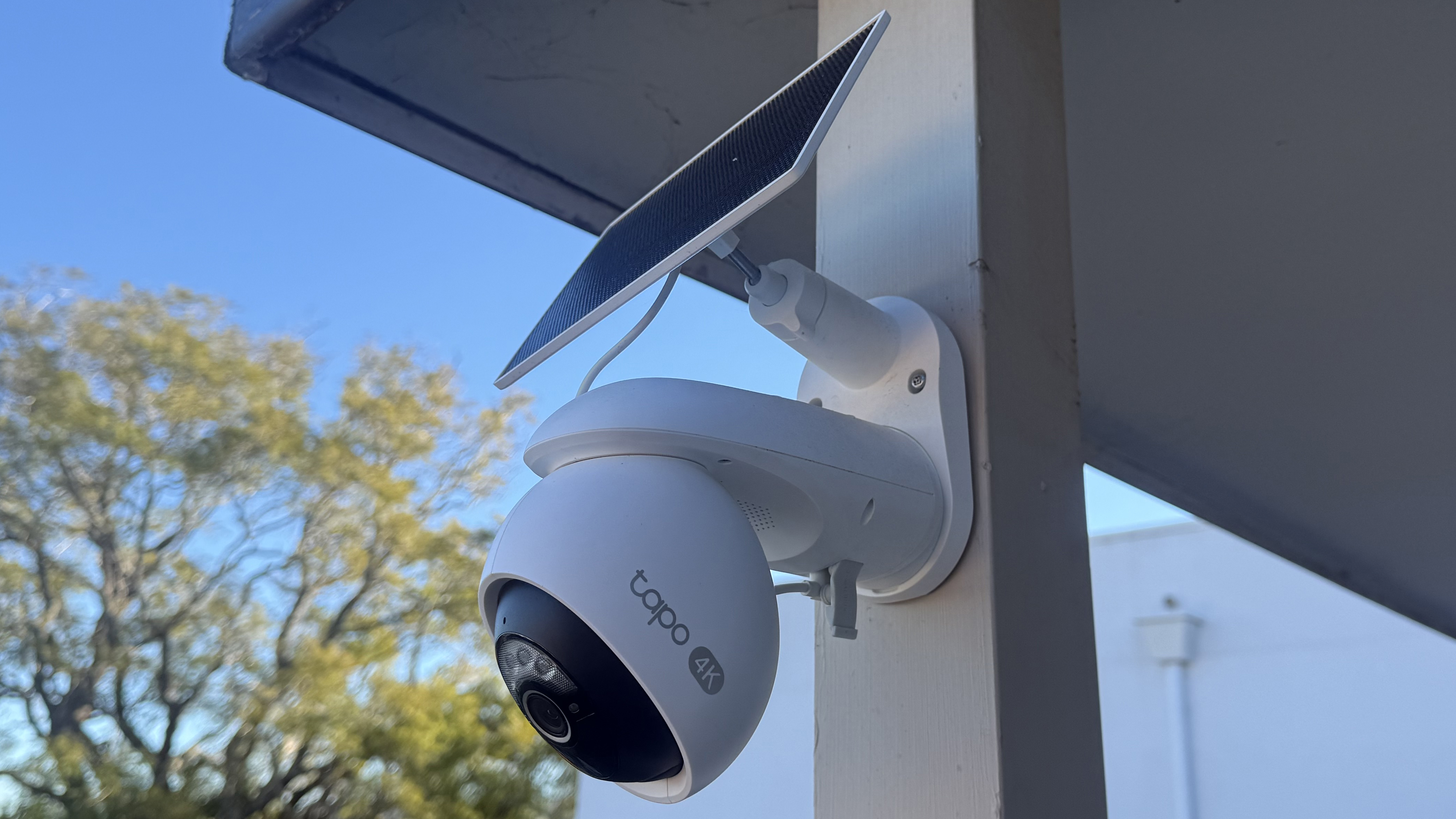A Tapo C660 Kit security camera mounted on a wooden pole