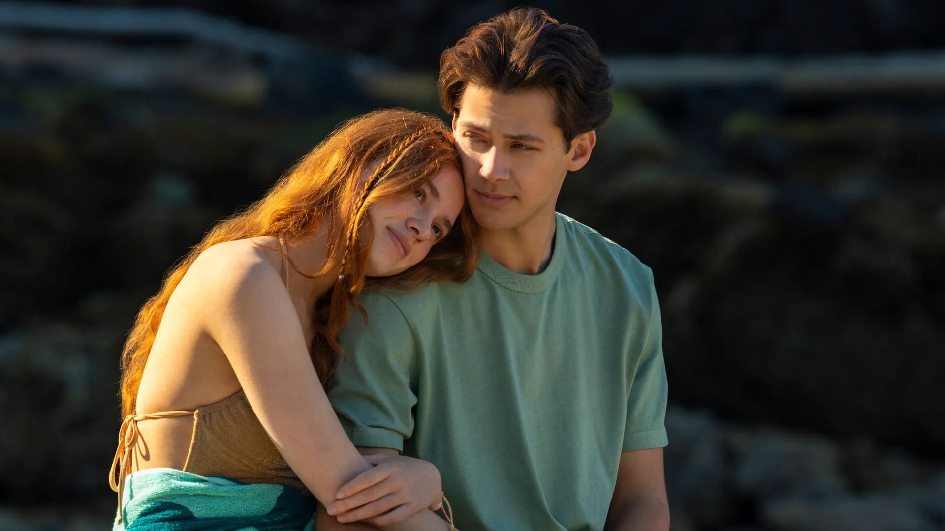 A young couple embrace on the beach