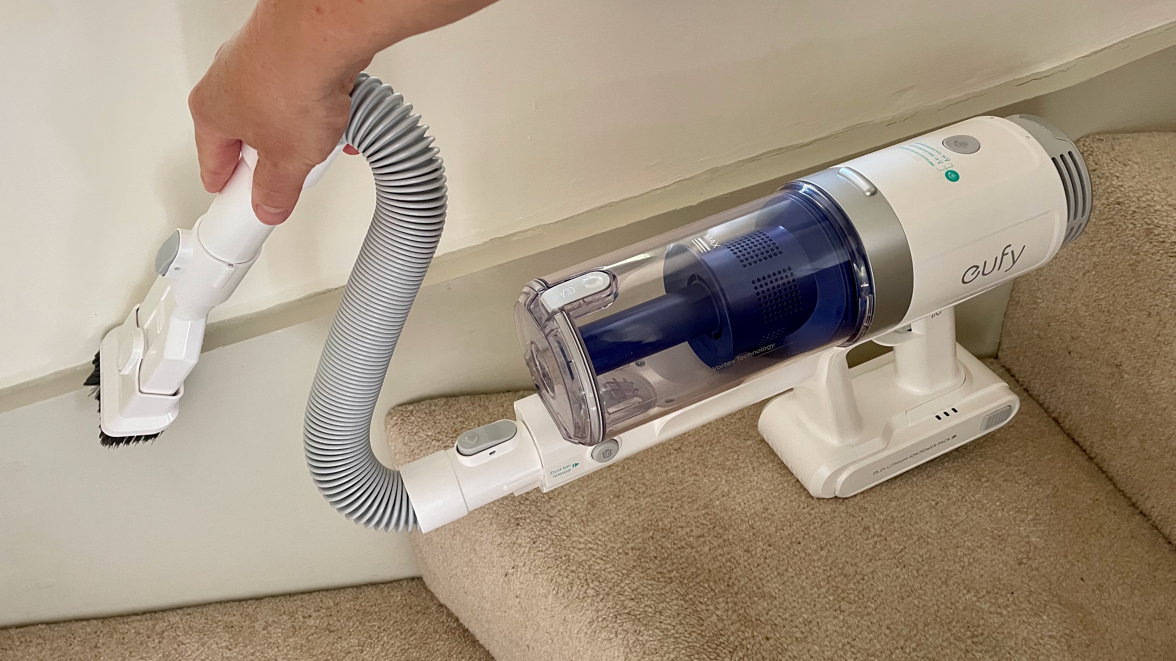 Eufy HomeVac S11 Infinity being used on carpeted stairs