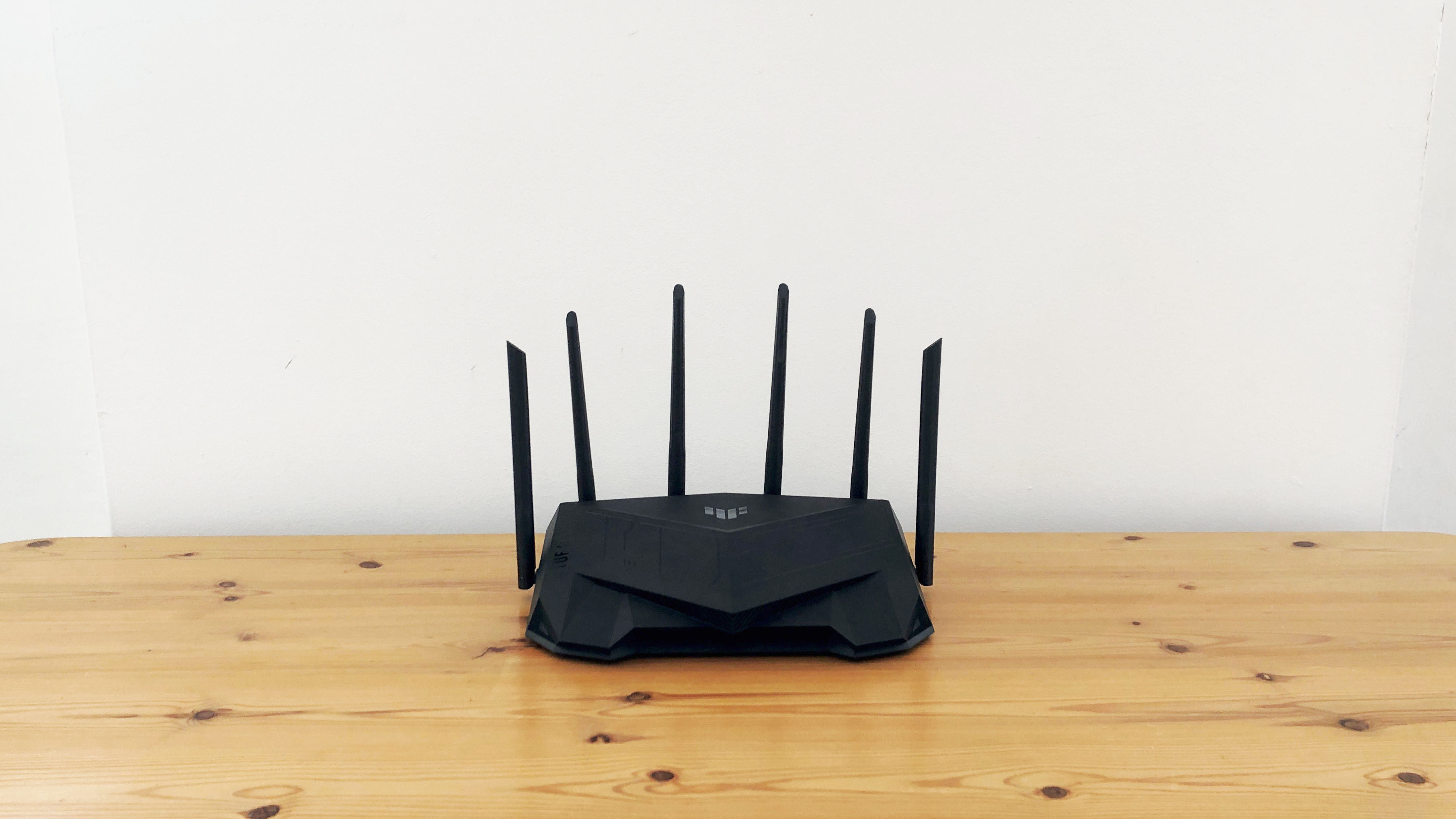 Asus TUF Gaming AX5400 on a wooden desk