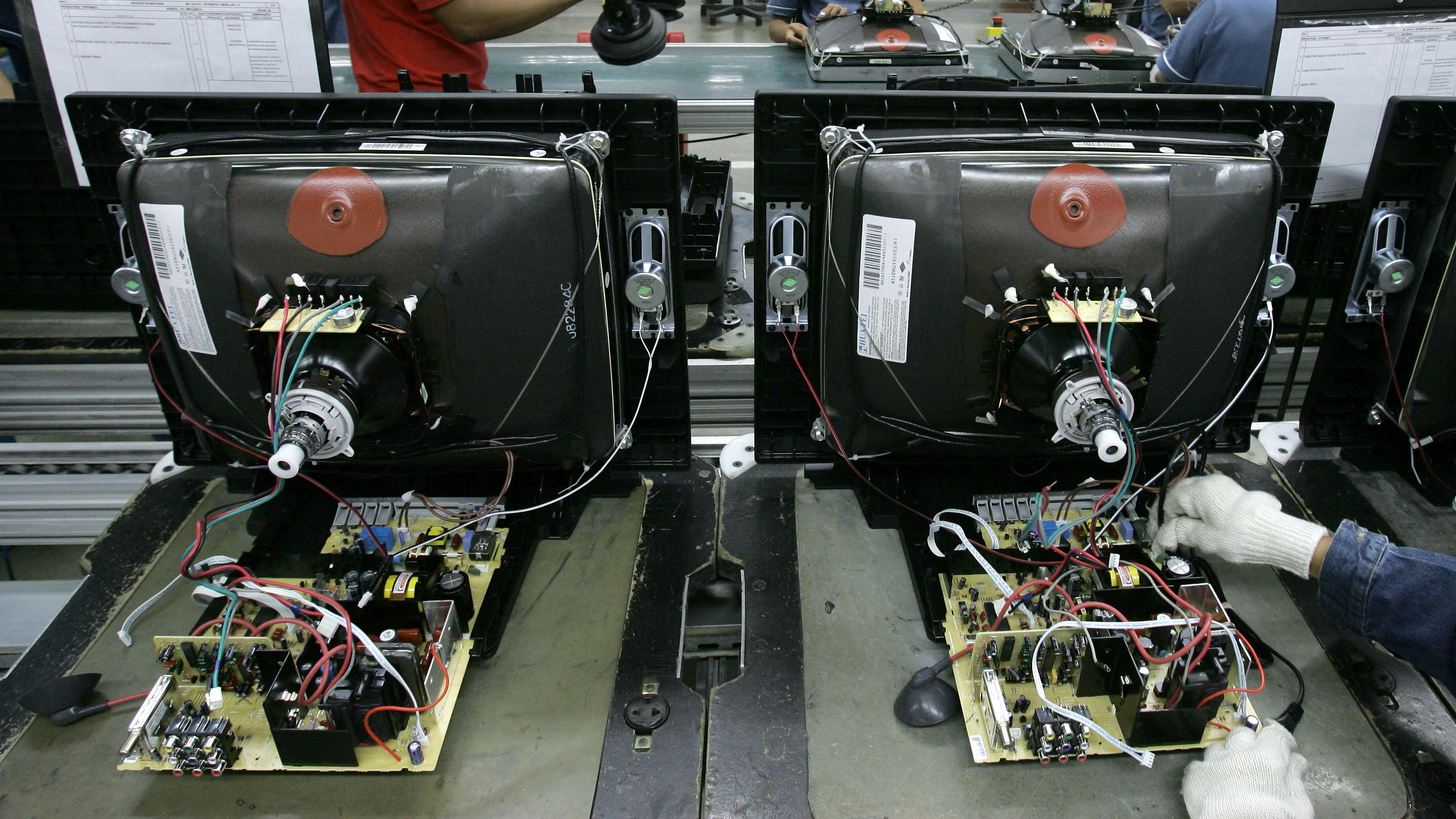 Workers assemble CRT television sets on the assembly line of Dutch electronics company Philips at the industrial pole in Manaus, northern Brazil