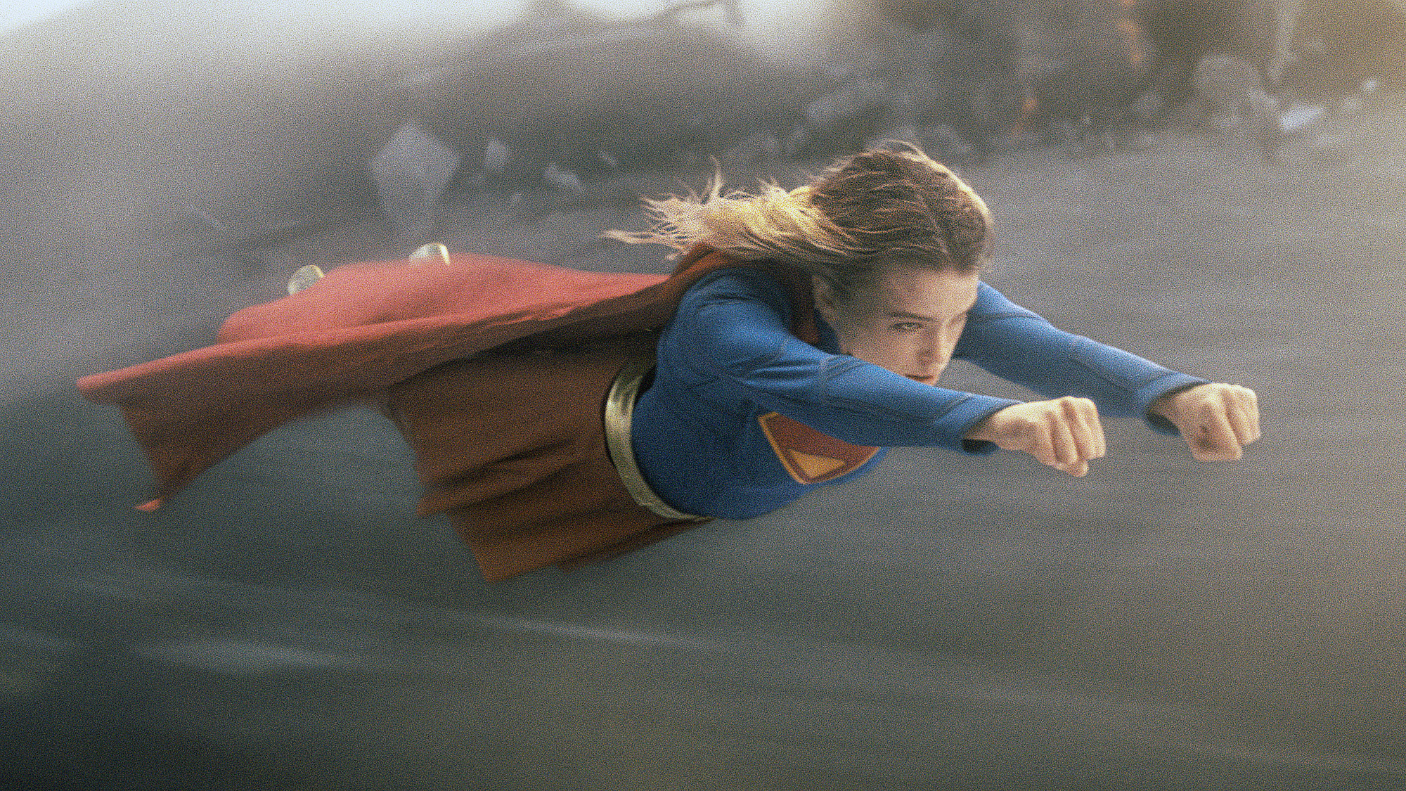 Milly Alcock's Kara Zor-El wearing her classic superhero suit as she flies through the air in 2026's Supergirl movie