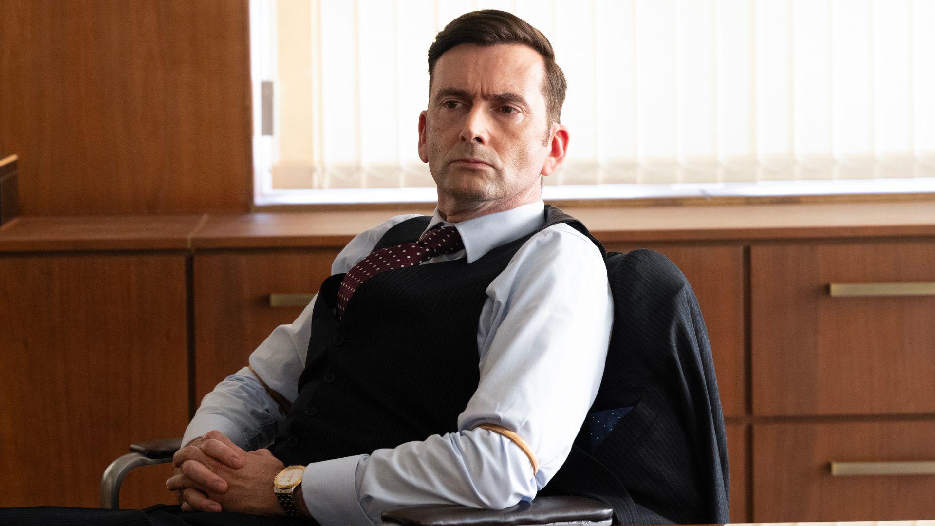 Tony Baddingham sits at his desk