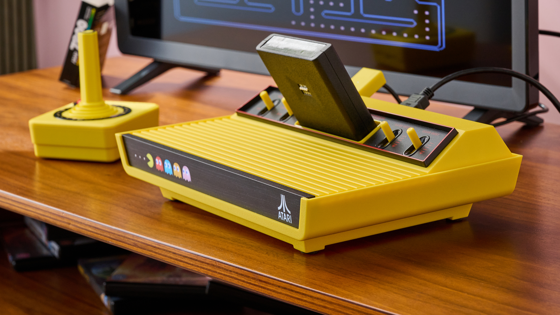 A three-quarters view of the Atari 2600+ Pac-Man Edition and the CX40+ joystick.