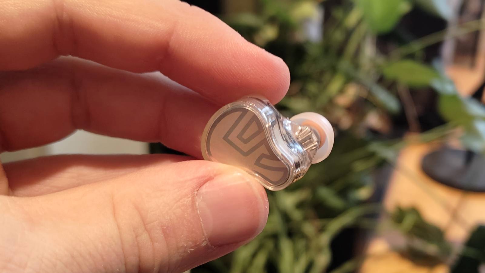 The Soundpeats H3 being held in a man's hand.