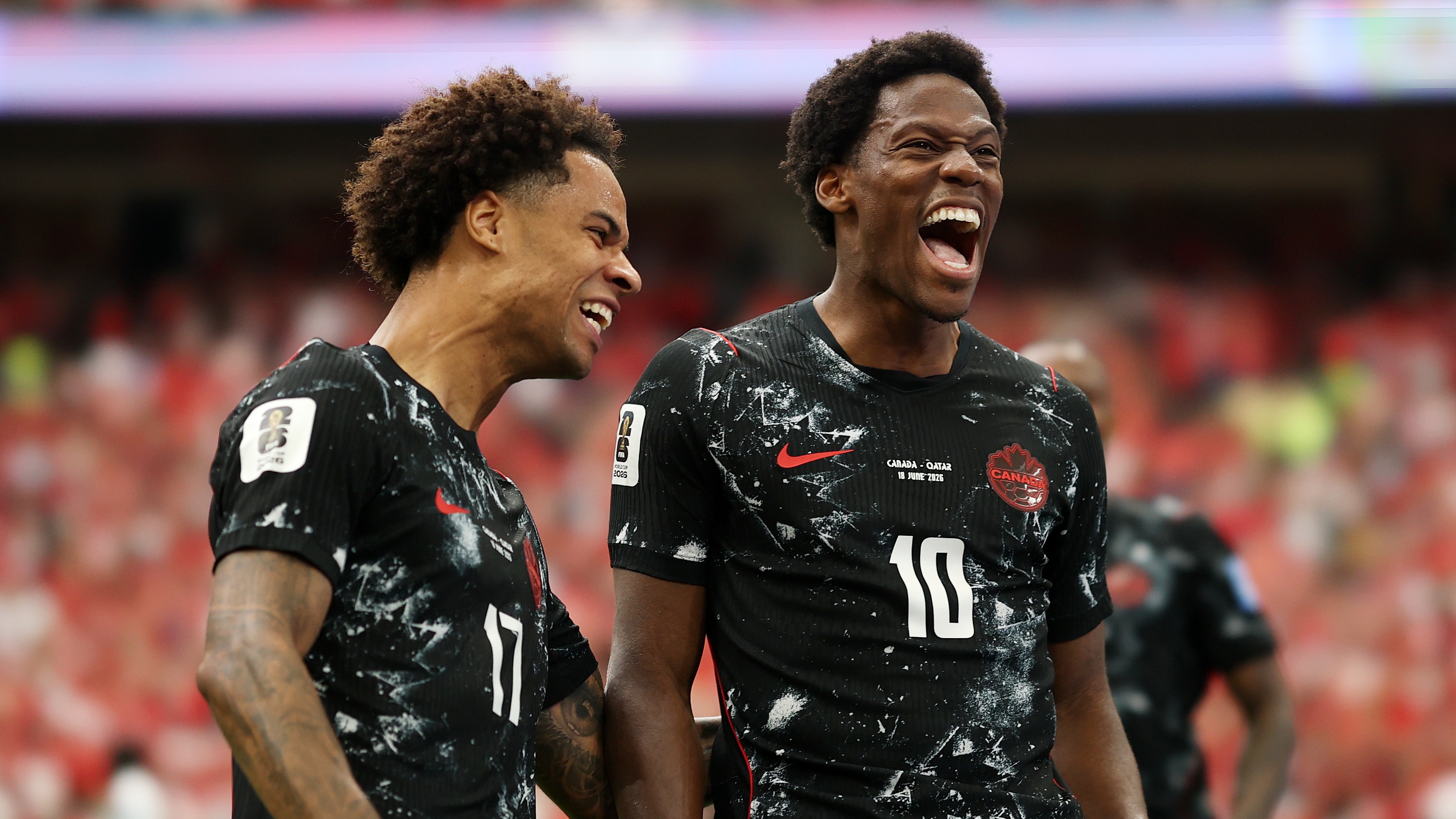 Jonathan David #10 of Canada celebrates with Tajon Buchanan #17 after scoring his team's second goal during the FIFA World Cup 2026 Group B against Qatar at BC Place Vancouver on June 18, 2026