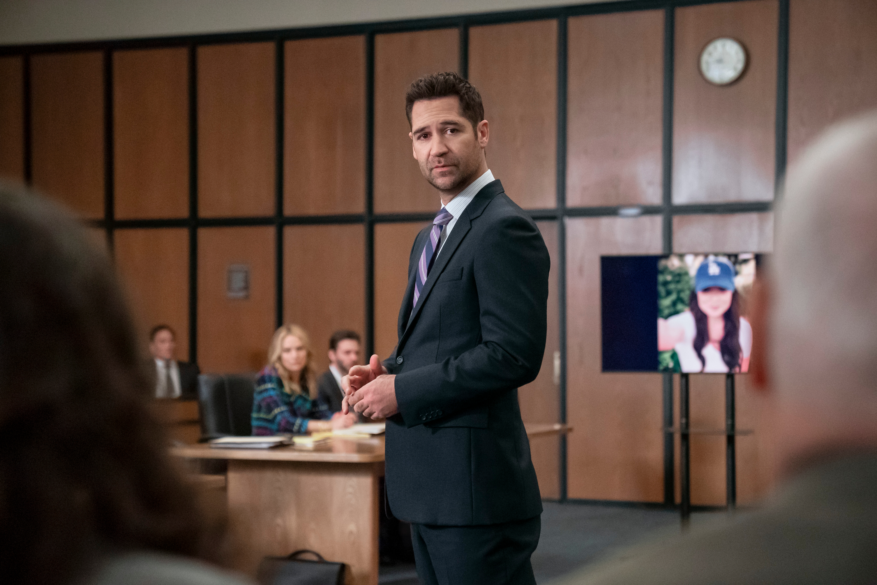Mickey stands in a court room full of people in The Lincoln Lawyer season 3