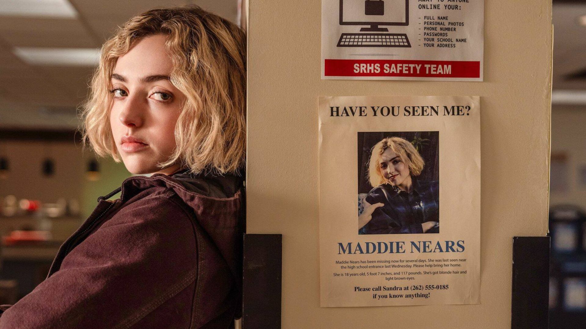 Maddie leans up against a pillar with a missing poster of her on it