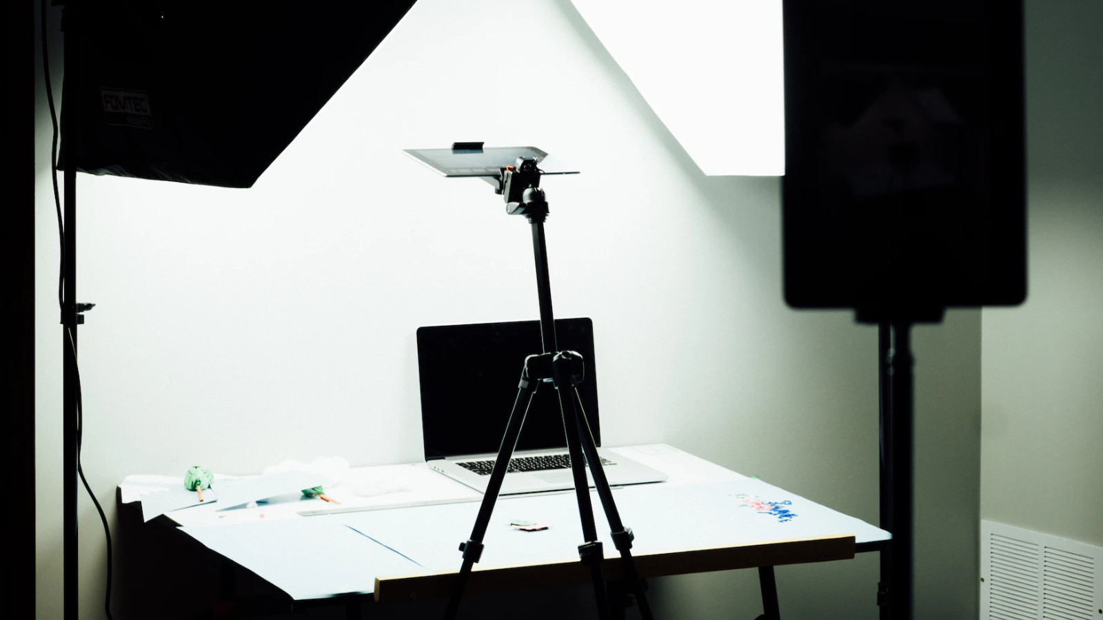 Laptop in an animation studio behind a tripod and cels