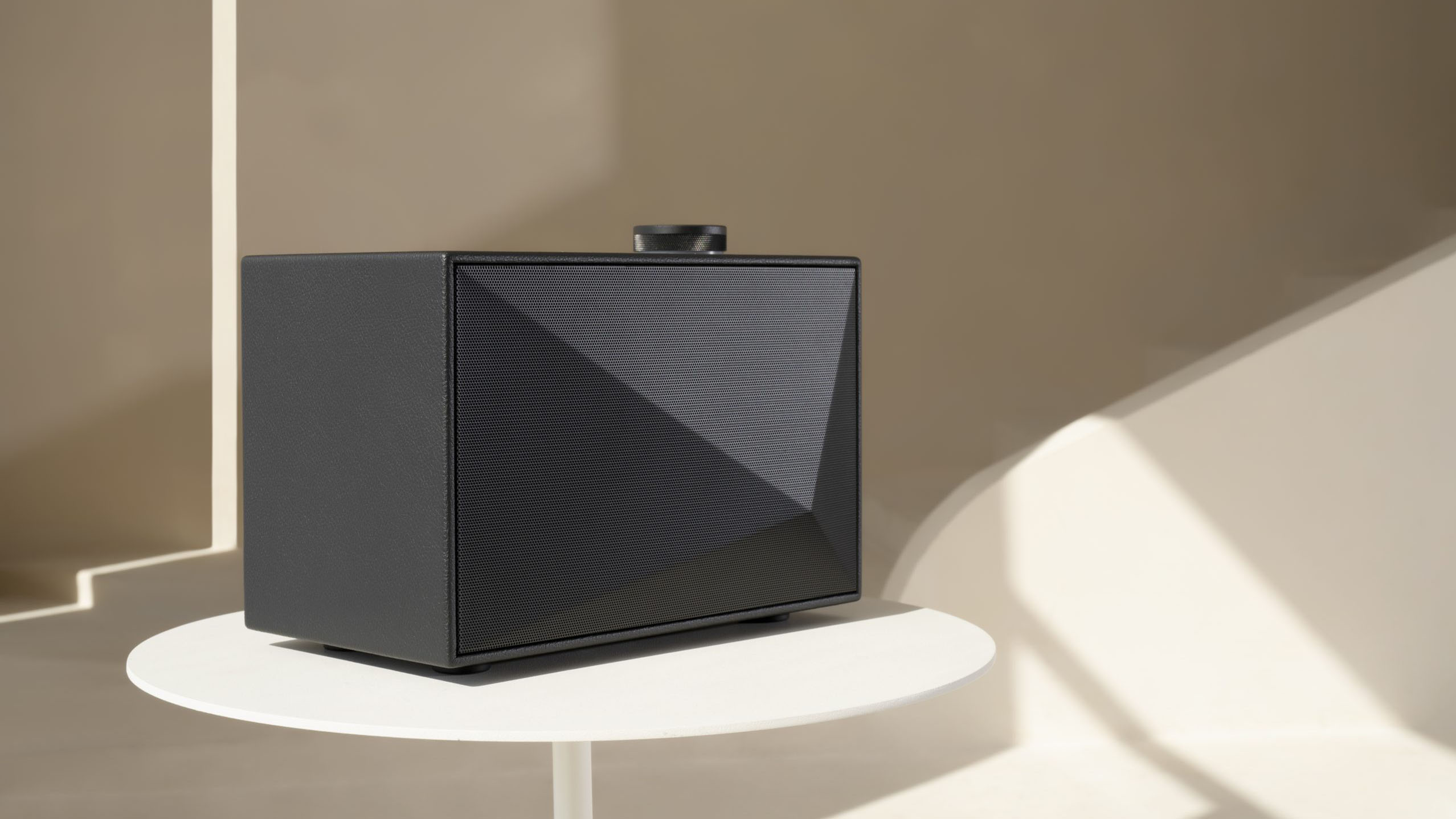 a wireless bluetooth speaker on a coffee table