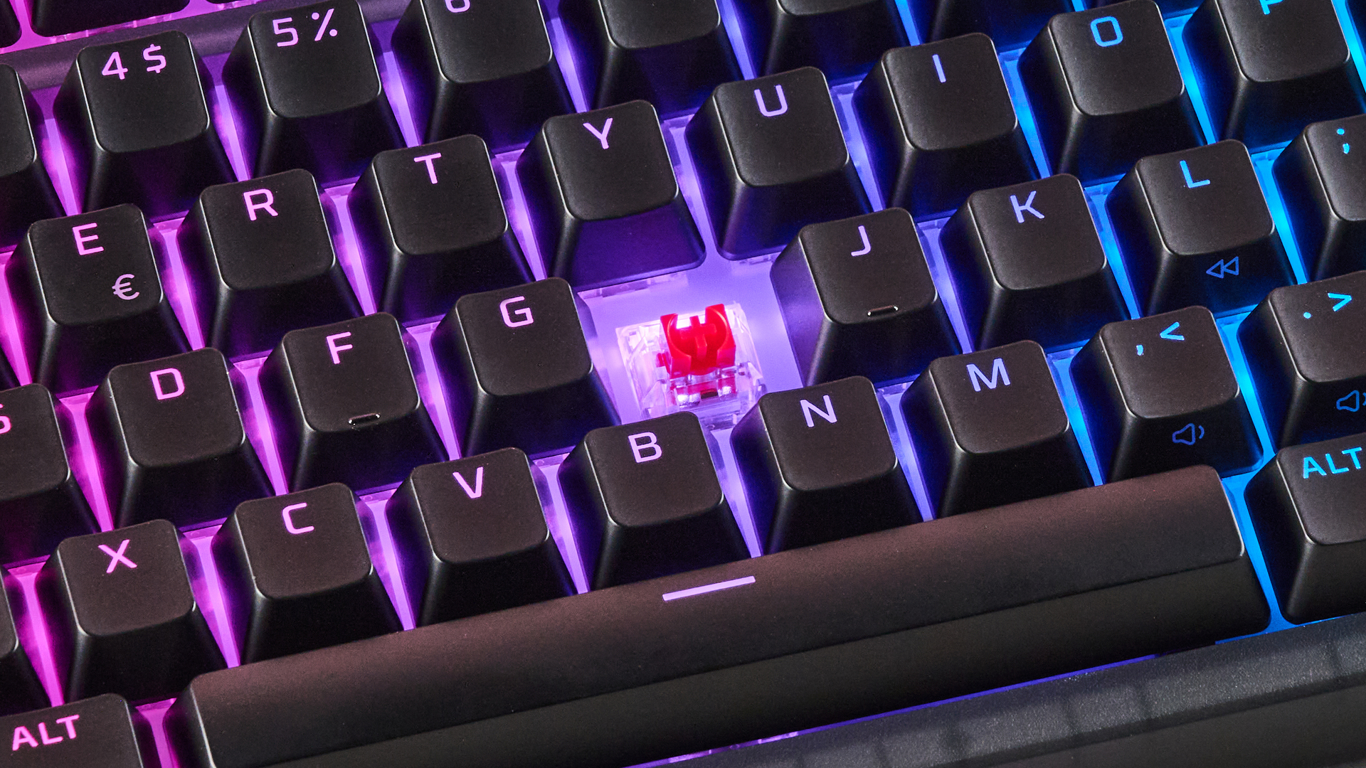 Close-up of switch underneath H key with keycap removed, with RGB backlighting on