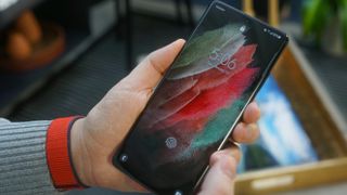 Samsung Galaxy S21 Ultra in a hand with the lockscreen on