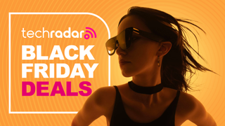 The Xreal One Pro glasses being worn by a woman on an orange background.