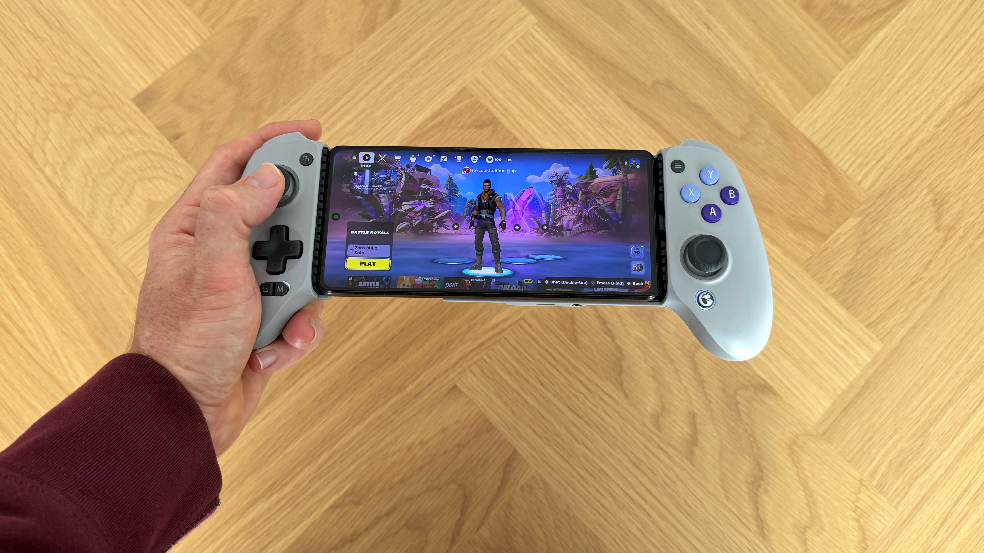 The GameSir G8 Galileo mobile gaming controller on a wooden surface.