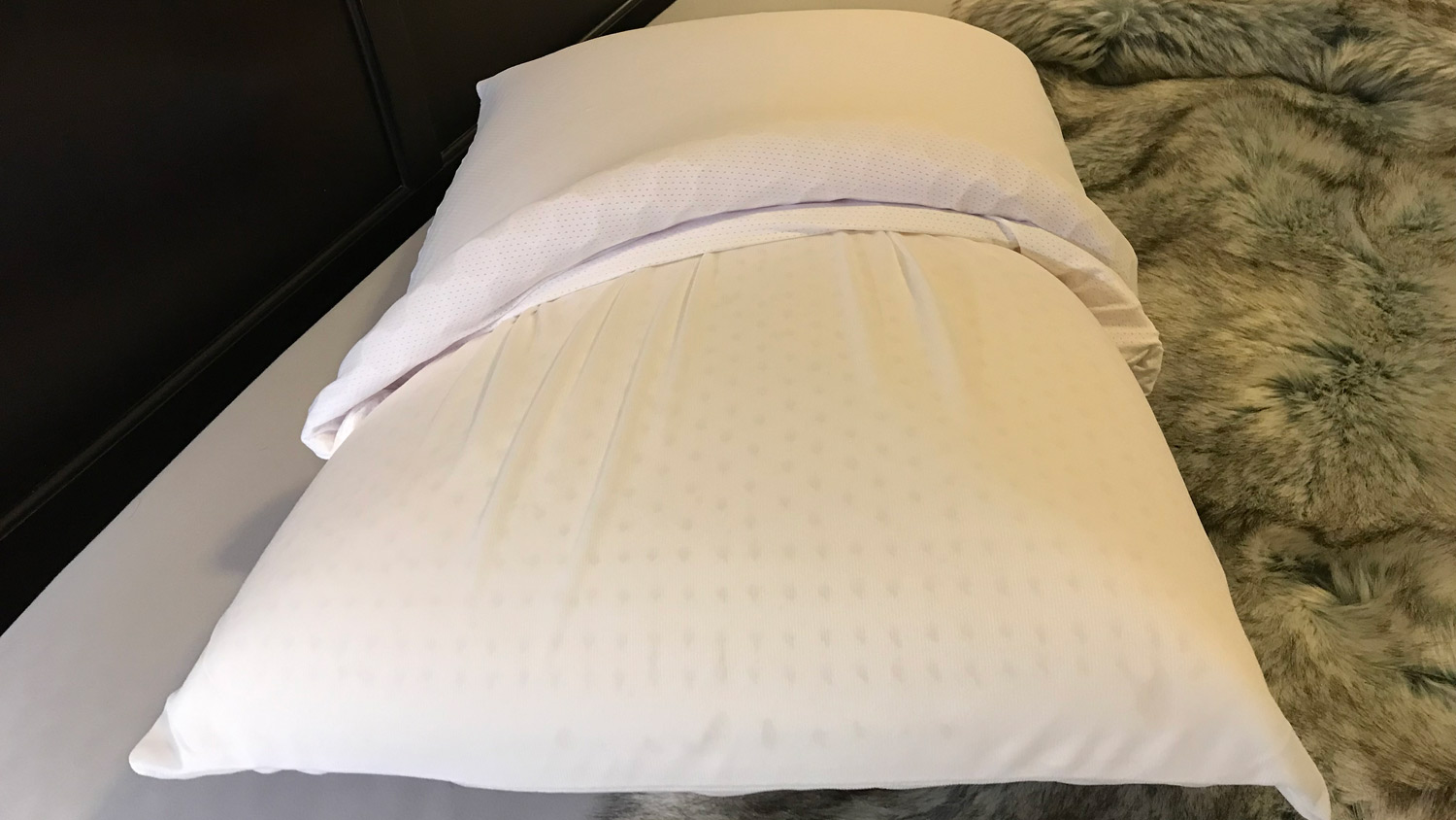 The Purple Harmony Pillow with the cover partially removed, showing the latex core