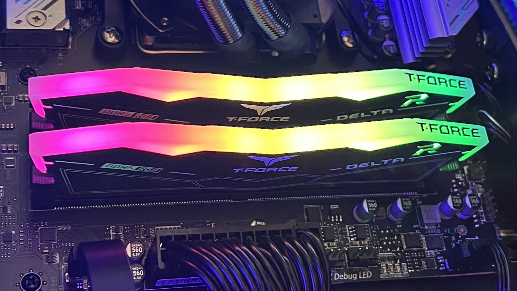 A set of TeamGroup T-Force Delta RGB DDR5 RAM modules in a motherboard