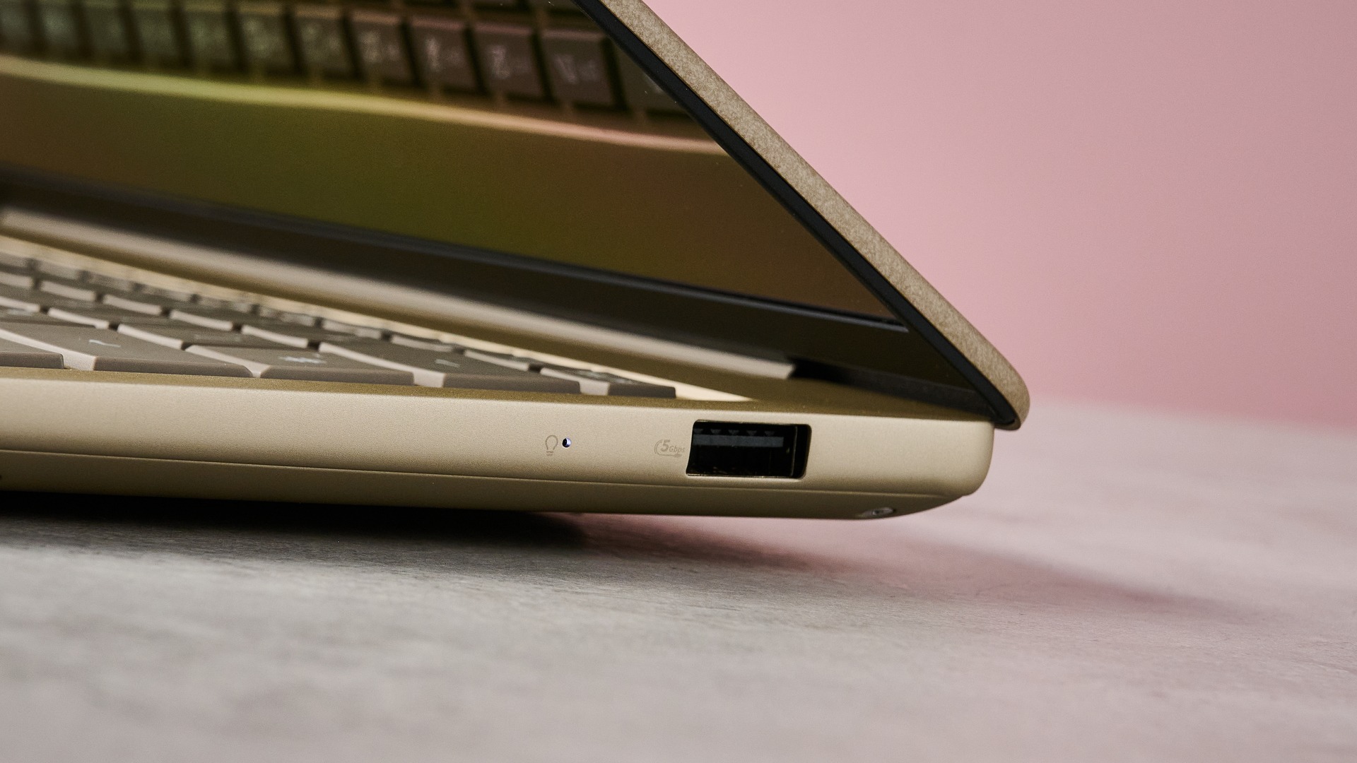 Close-up of USB-A port on right-hand side of Asus Zenbook 14 2026 with pink wall in background