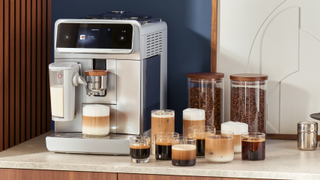 Philips Caf&eacute; Aromis coffee maker on kitchen counter with a variety of coffee drinks