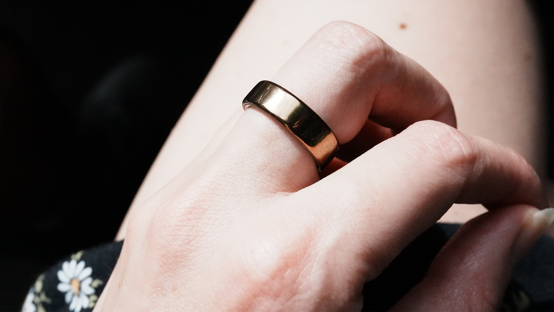 A close up of a hand wearing the Oura Ring 5