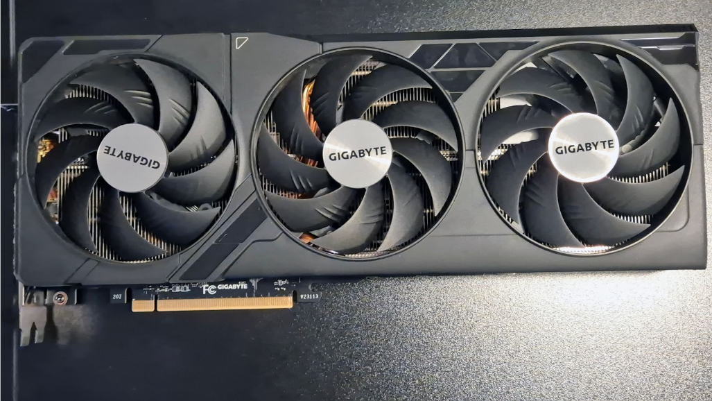 A disconnected graphics card sitting on top of a black PC case