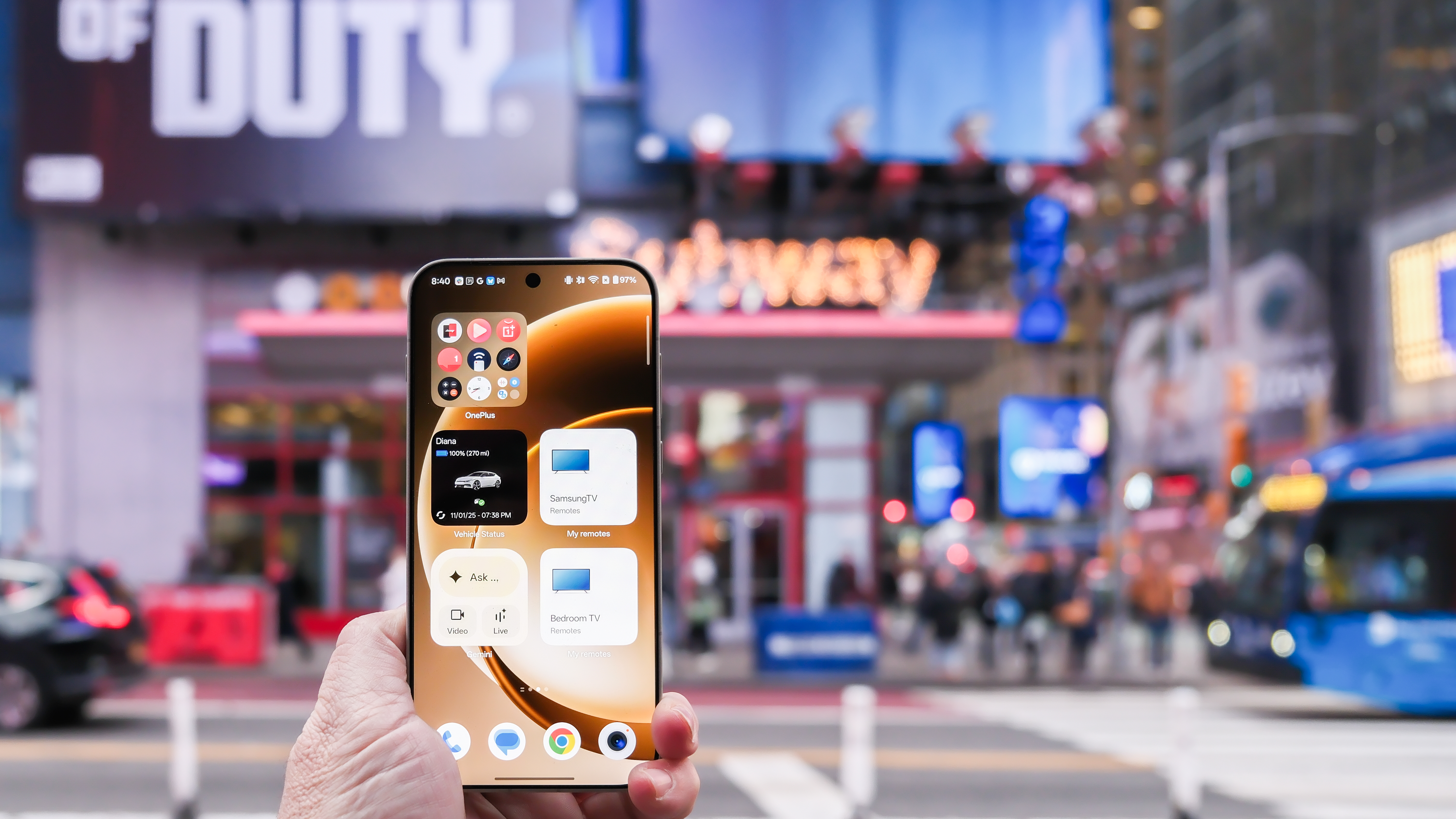 OnePlus 15 in Times Square New York City on the busy street showing the cameras and sides of the phone in addition to home screen panels and Settings menus
