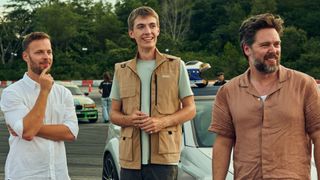 James, Francis and Thomas look at something on a racetrack