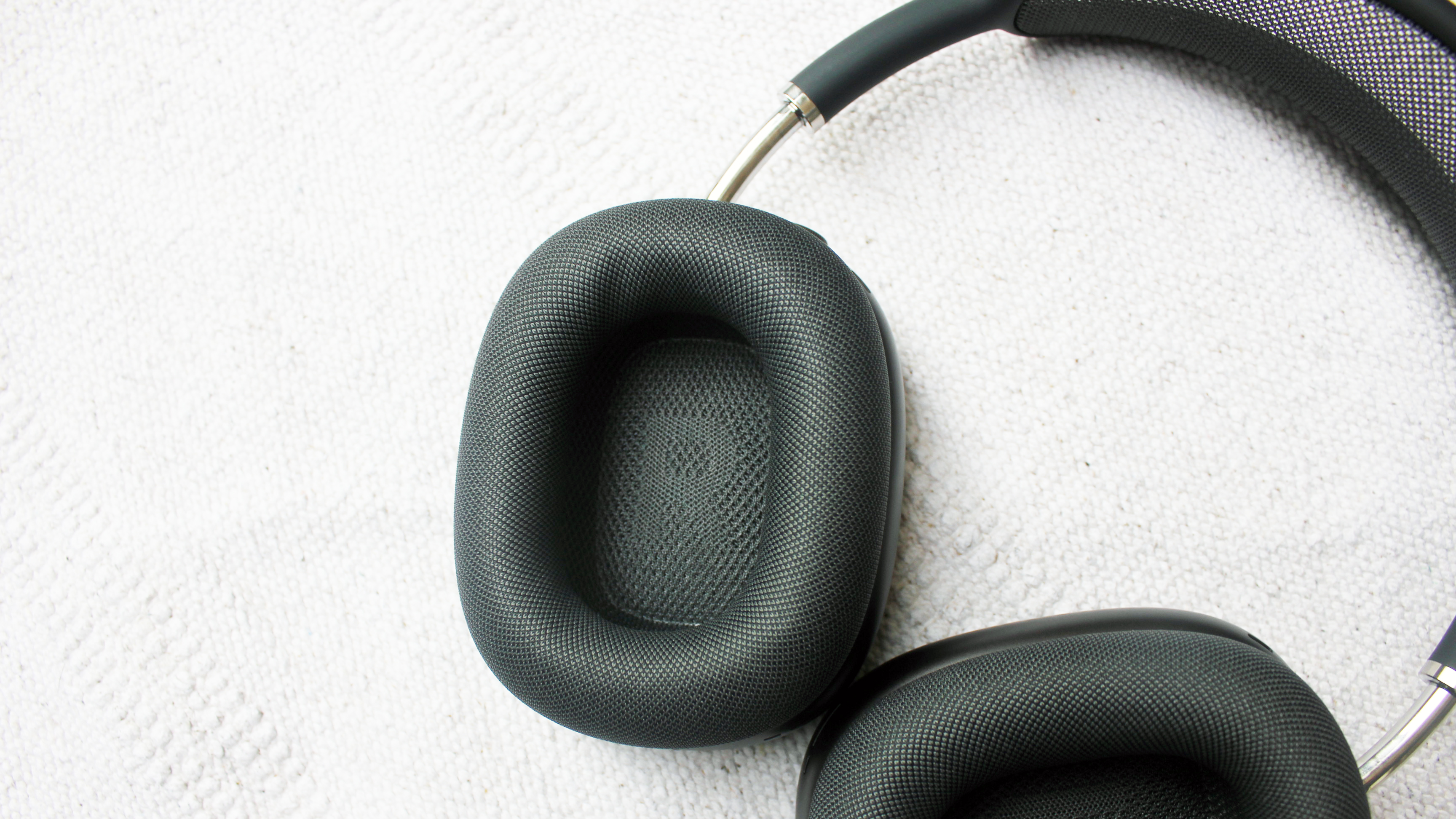 A close up of the earcups of the Apple AirPods Max headphones
