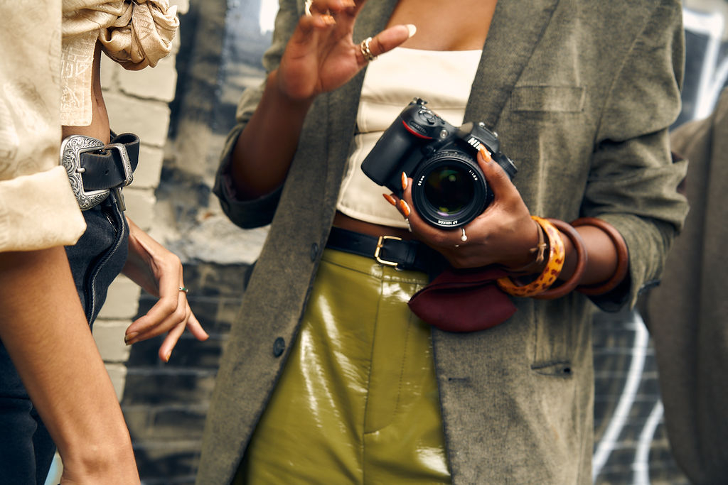 Someone holding a Nikonc camera