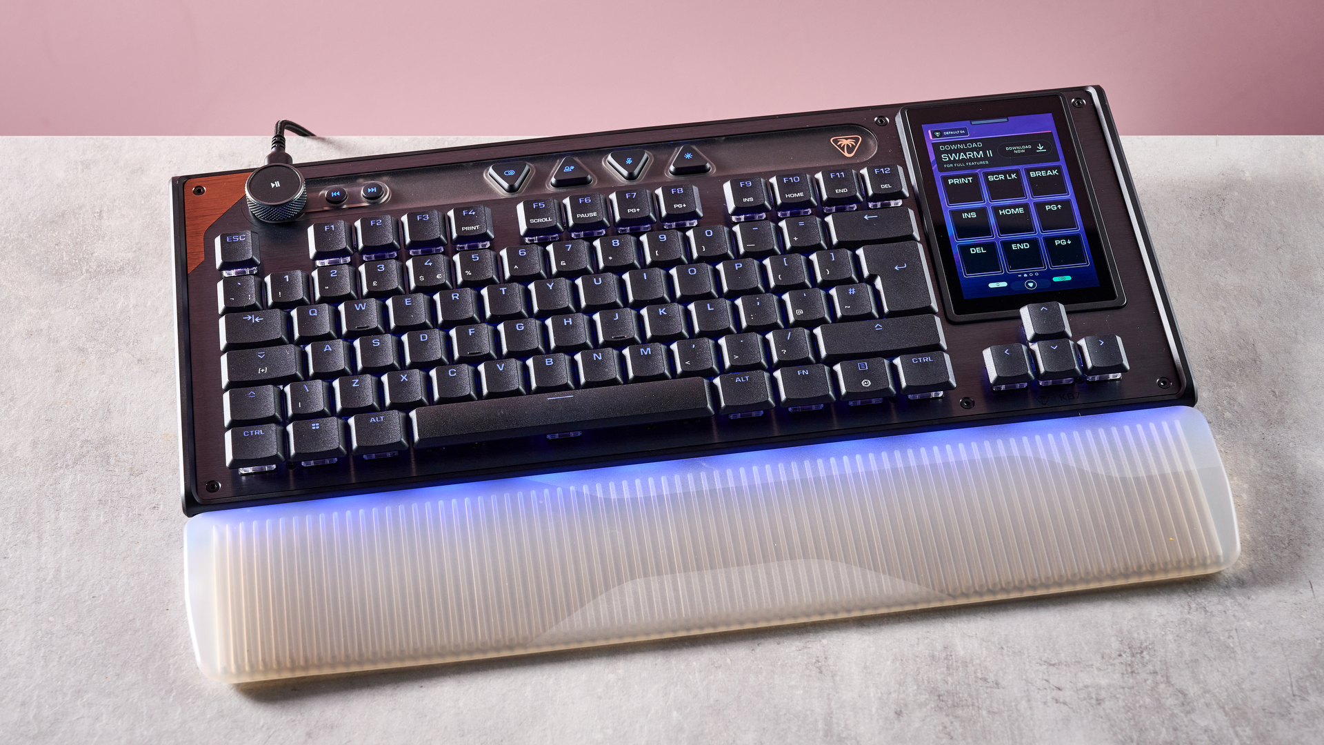 The Turtle Beach Command Series KB7 and wrist rest at a slight angle in front of a pink background.