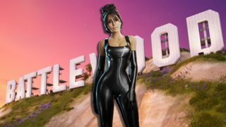 Kim Kardashian standing in front of the 'Battlewood' sign as the sun sets behind her